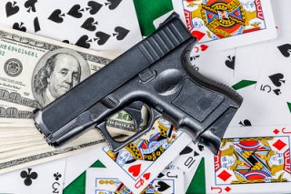 Gun, money and playing cards background